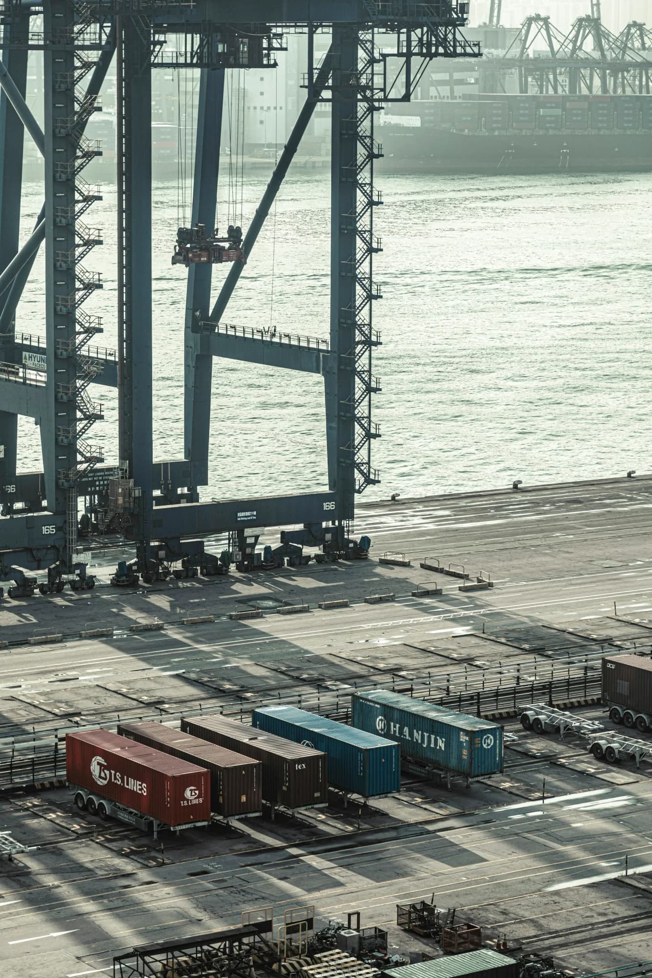 Container gantry cranes and freight shipping operations at a terminal dock