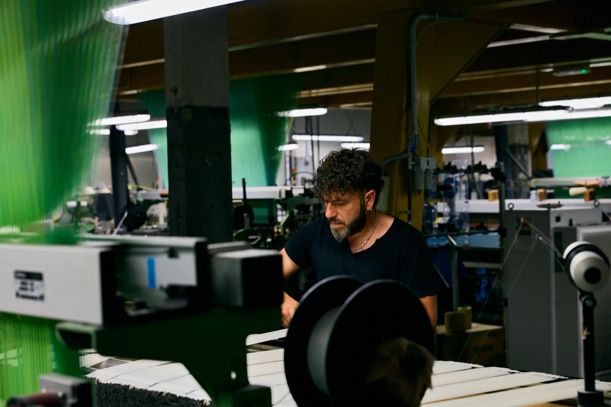 Technician operating industrial machinery in a manufacturing facility